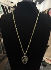 gold rope chain necklace features a gothic skull pendant with red stone eyes
