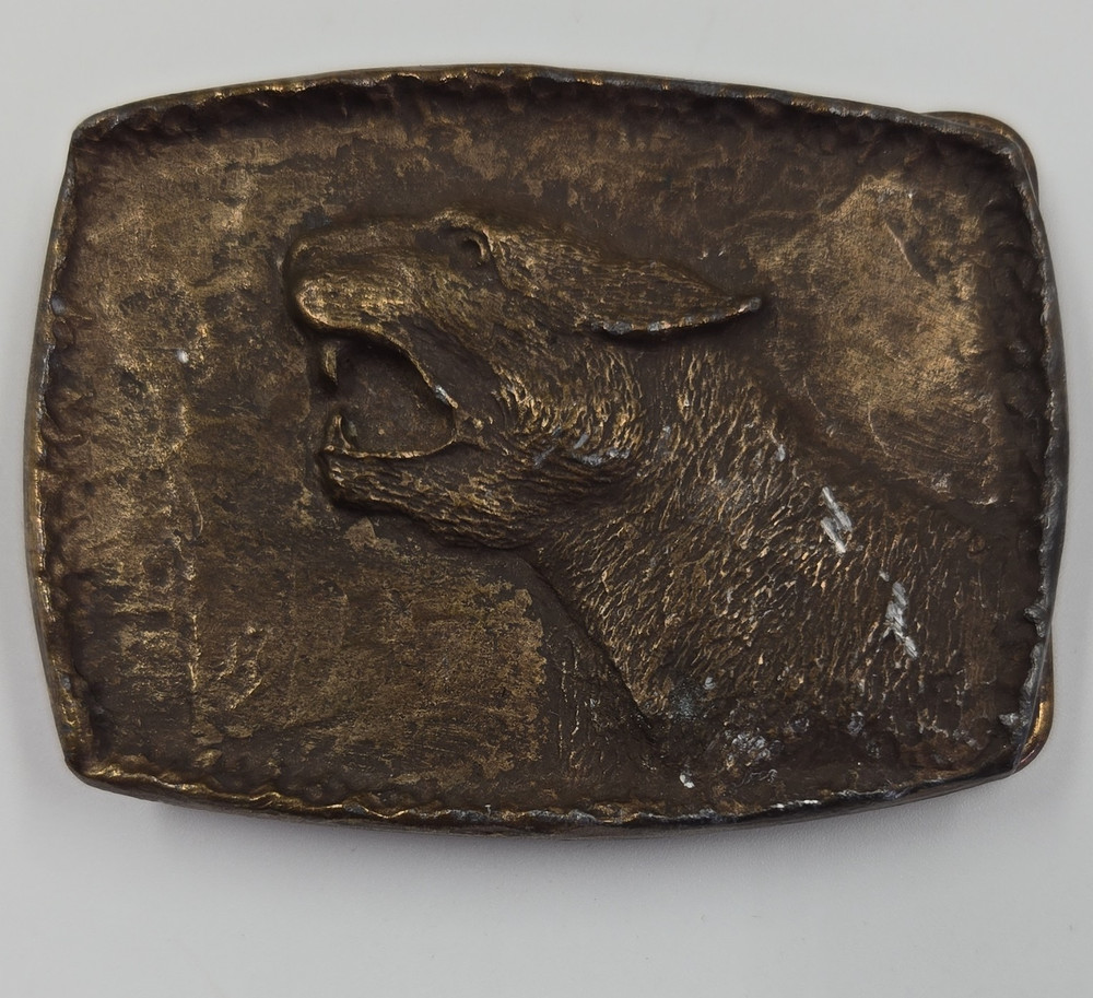 vintage solid brass or bronze novelty belt buckle featuring a roaring cougar