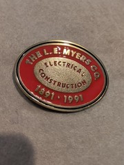 L.E. Myers Co Electrical Construction 1891-1991 Oval Red/Gold Metal Belt Buckle