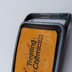 NL Treating Chemicals Belt Buckle Yellow Vintage Distressed Well Worn