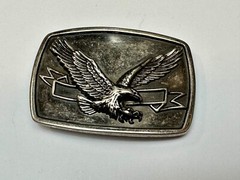 American Eagle With Wings Wide Flying High In Front Of Ribbon Belt Buckle