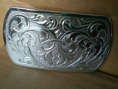 2 silver tone shiny belt buckles