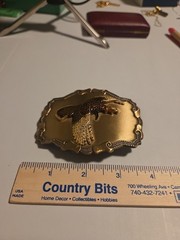 large brass colored metal belt buckle with pheasant in flight