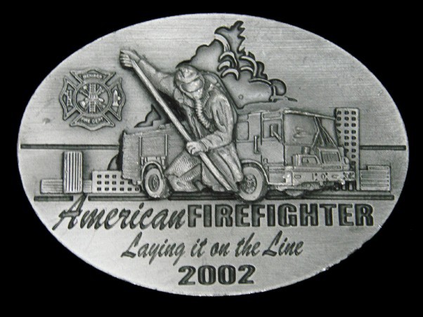 TA17159 2002 **AMERICAN FIREFIGHTER LAYING IT ON THE LINE** COMMEMORATIVE BUCKLE