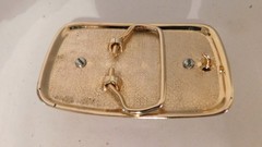 Gold rectangled belt buckle with brown oval stone