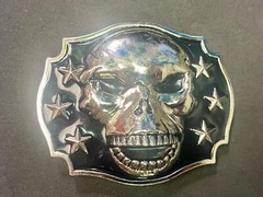 Raised Skull With Teeth Grin Black And Silver Color Belt Buckle Star Surround