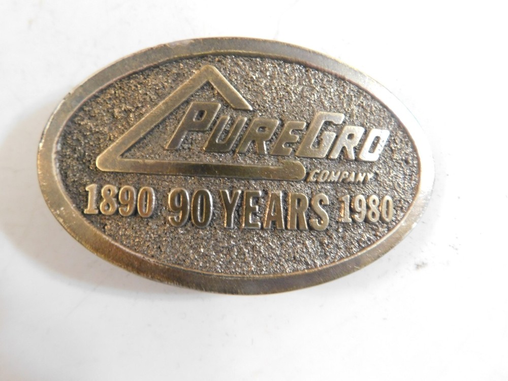 1980 PURE GRO BELT BUCKLE BY THE GREAT AMERICAN BUCKLE CO. BRASS