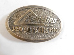 1980 PURE GRO BELT BUCKLE BY THE GREAT AMERICAN BUCKLE CO. BRASS
