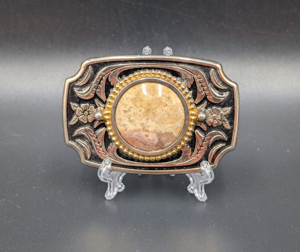 Black in lay silver toned belt buckle with marbled faux stone outlined is raised