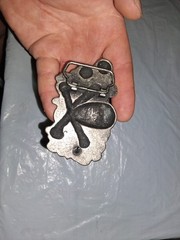 unbranded gothic belt buckle features a 3D pile of skulls and crossed bones…