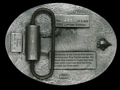 TA17159 2002 **AMERICAN FIREFIGHTER LAYING IT ON THE LINE** COMMEMORATIVE BUCKLE