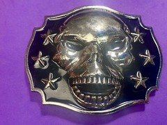 Raised Skull With Teeth Grin Black And Silver Color Belt Buckle Star Surround