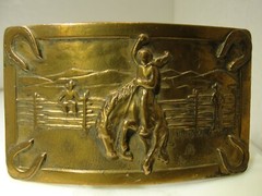 JUSTIN BELT CO. BRASS MATERIAL, IN GOOD CONDITION