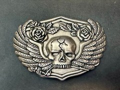 Dimensional Skull Head With Wings And Flowers – Raised Belt Buckle