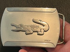 Silver-toned metal belt buckle, embossed crocodile logo and « ITALY »