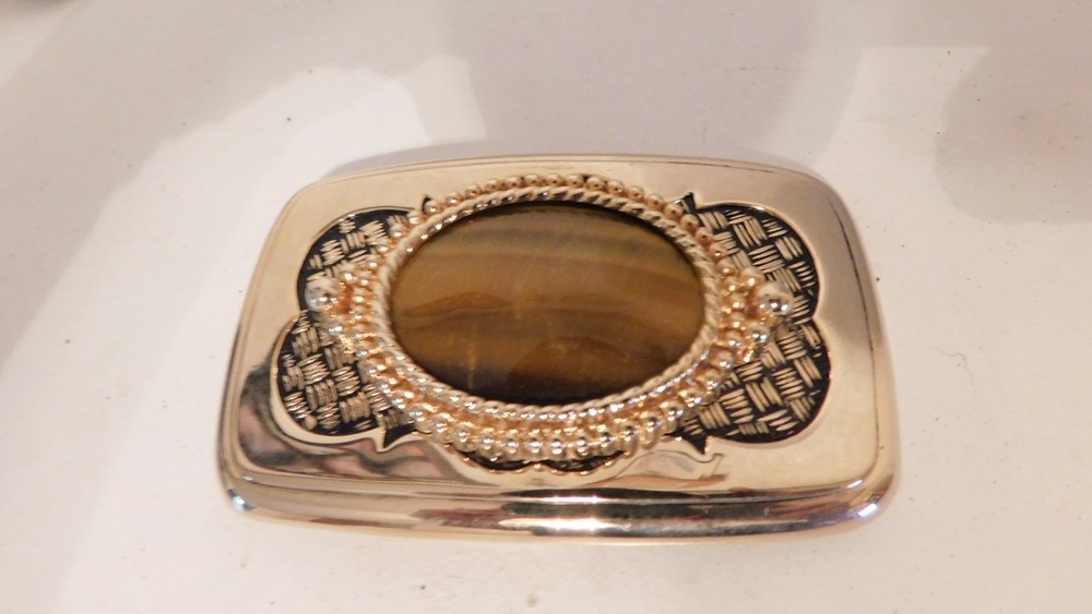 Gold rectangled belt buckle with brown oval stone