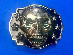 Raised Skull With Teeth Grin Black And Silver Color Belt Buckle Star Surround
