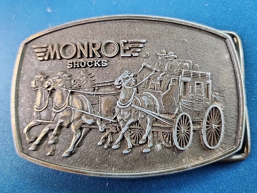 VTG 1980s MONROE SHOCKS BELT BUCKLE WILD WEST STAGECOACH SOFT RIDE