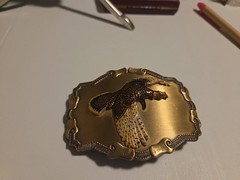 large brass colored metal belt buckle with pheasant in flight