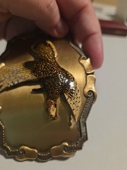 large brass colored metal belt buckle with pheasant in flight