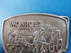 VTG 1980s MONROE SHOCKS BELT BUCKLE WILD WEST STAGECOACH SOFT RIDE