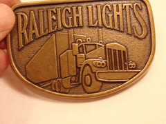 Modern brass colored advertising / trucker belt buckle: Raleigh Lights