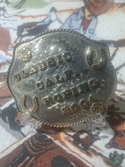 Calf roping buckle, nickle silver dated 2004 with horse shoes and flowers