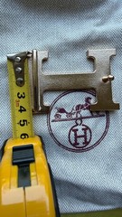Hermès belt buckle in polished palladium, complete with its signature pouch