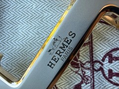 Hermès belt buckle in polished palladium, complete with its signature pouch