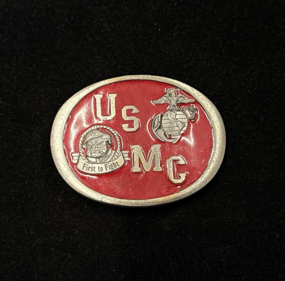 Vintage USMC belt buckle features red enamel background “First to Fight” RARE