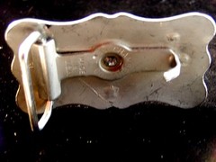 Bronco riding belt buckle with star design