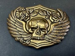 Dimensional Skull Head With Wings And Flowers – Raised Metal Belt Buckle