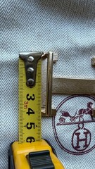 Hermès belt buckle in polished palladium, complete with its signature pouch