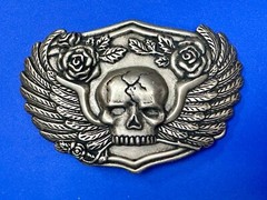 Dimensional Skull Head With Wings And Flowers – Raised Belt Buckle