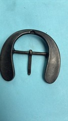 This vintage-style, handmade steel belt buckle is shaped like a horseshoe