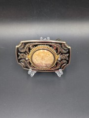 Black in lay silver toned belt buckle with marbled faux stone outlined is raised