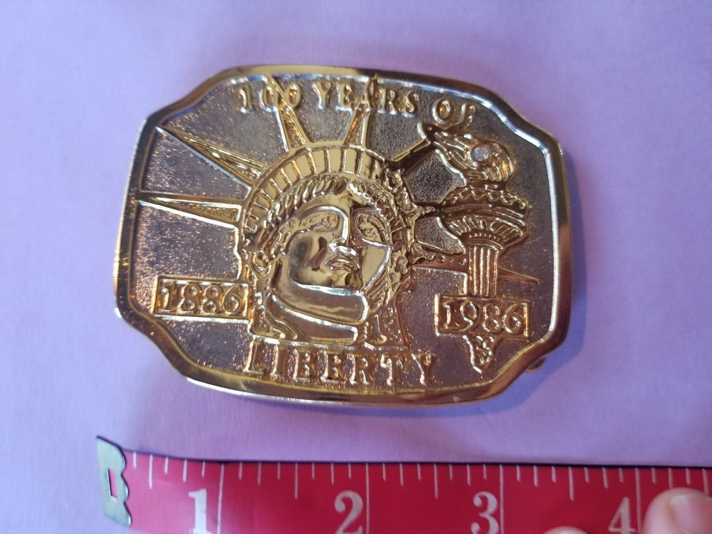 1986 Goldtone 100 years of Liberty belt buckle 3.5&Prime; x 2.5&Prime;