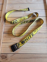 Off-White Industrial Belt in the yellow and black colorway, featuring a black…