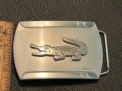 Silver-toned metal belt buckle, embossed crocodile logo and « ITALY »