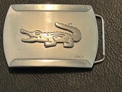 Silver-toned metal belt buckle, embossed crocodile logo and « ITALY »
