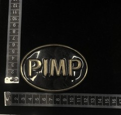 Vintage Rage « PIMP » belt buckle features a black and silver design RARE