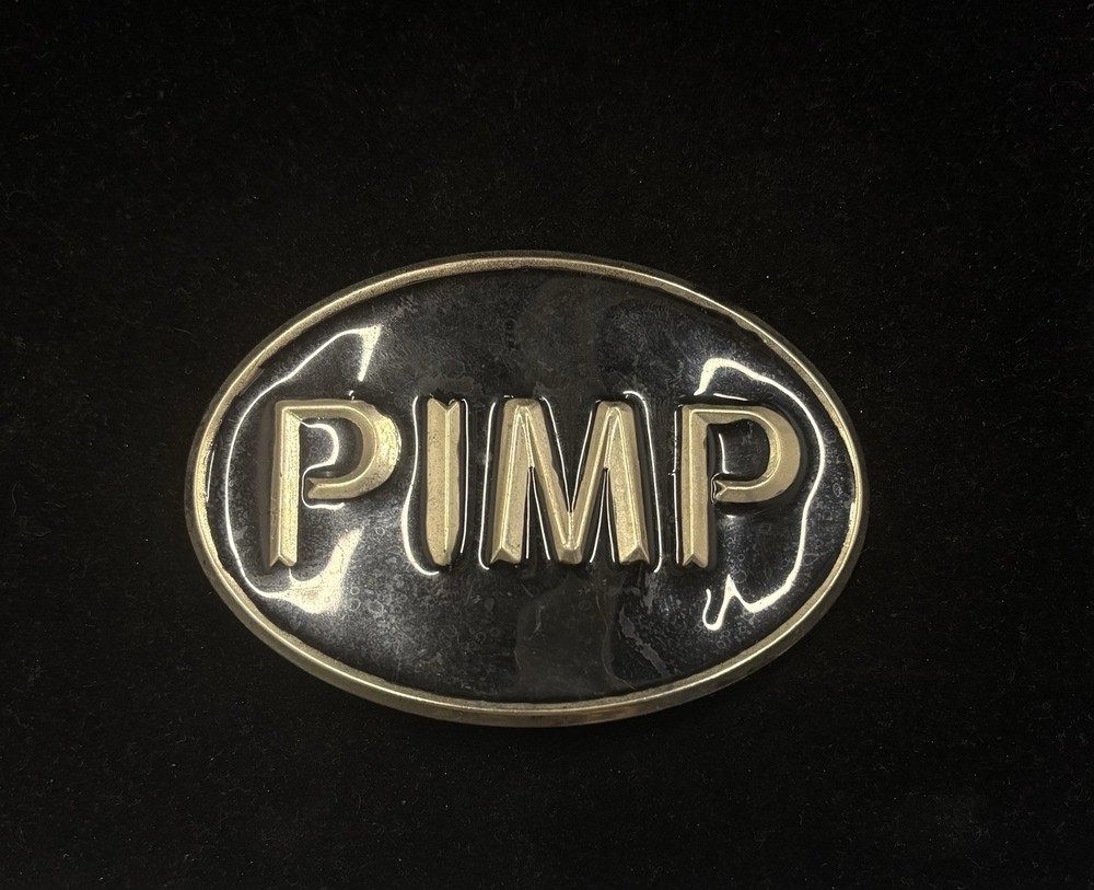 Vintage Rage « PIMP » belt buckle features a black and silver design RARE