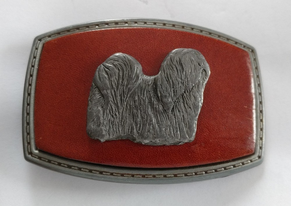 LONG HAIR DOG LHASA APSO ON A RED LEATHER PIECE SET ON A BELT BUCKLE