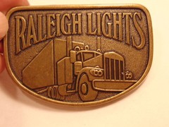 Modern brass colored advertising / trucker belt buckle: Raleigh Lights