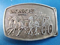 VTG 1980s MONROE SHOCKS BELT BUCKLE WILD WEST STAGECOACH SOFT RIDE